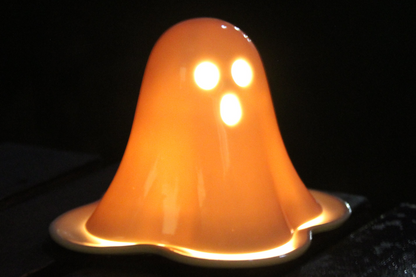 Playful ghost candle holder displayed on a wooden shelf for cosy home styling