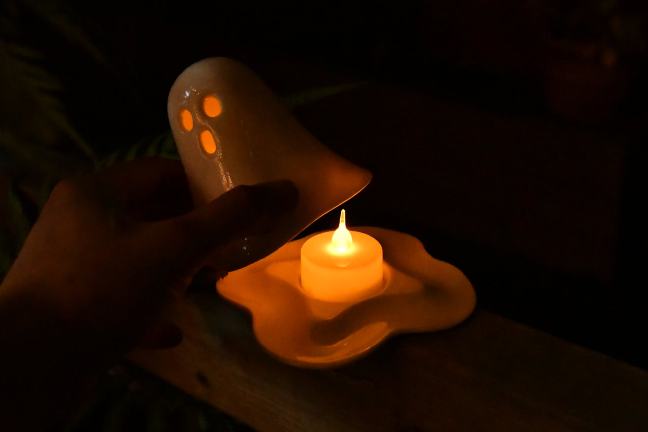 Handmade ceramic ghost tealight holder with a standard tealight candle