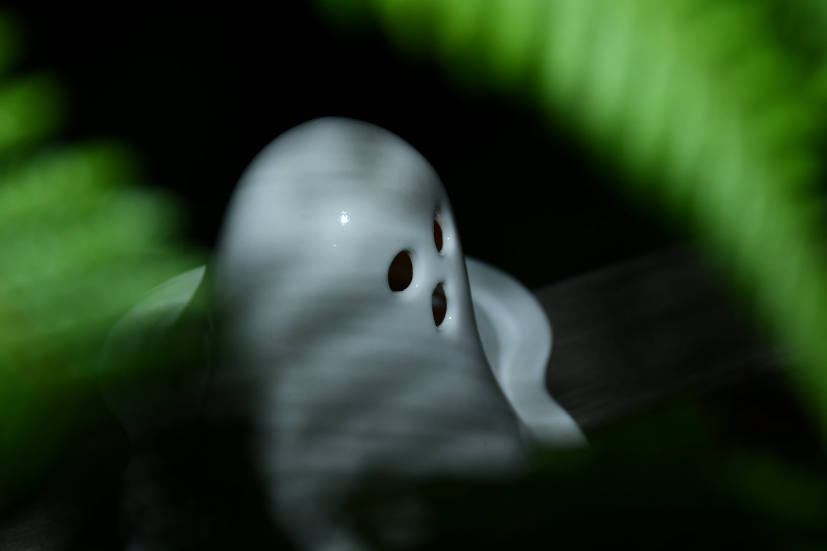 Ceramic ghost tealight holder showing the candle opening from above