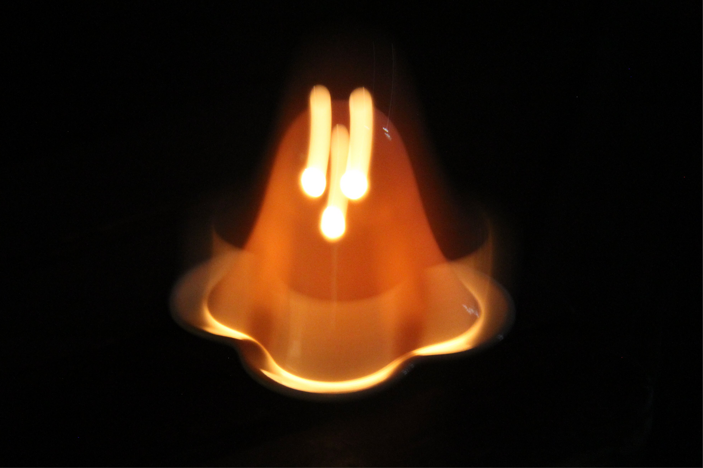 Ceramic ghost tealight holder showing the candle opening from above